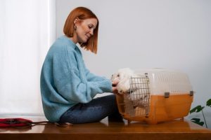 owner with dog inside cage